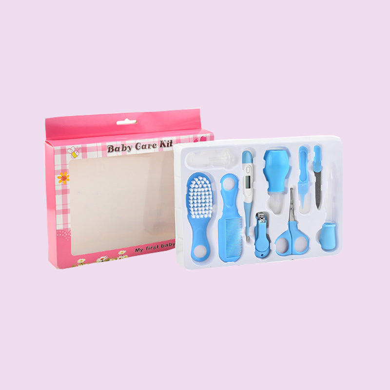 Baby care kit with blue tools in a pink box on a light purple background