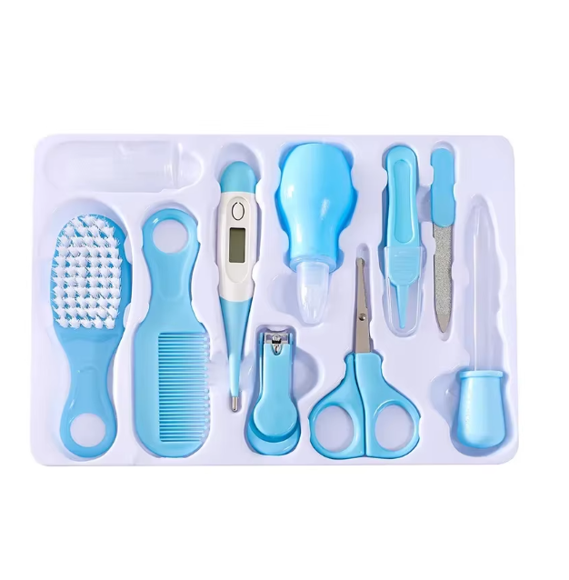 Set of blue baby care tools including a brush, comb, thermometer, and scissors on a white background.